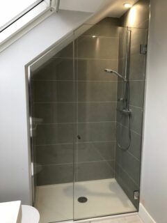 frameless glass shower enclosure for narrow attic space grey tiles