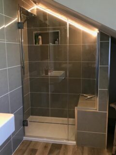 designer loft shower enclosure with tile seat - sloping ceiling