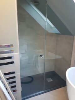 Loft shower enclosure with Velux window